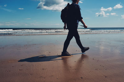 Full length of man on beach against sky