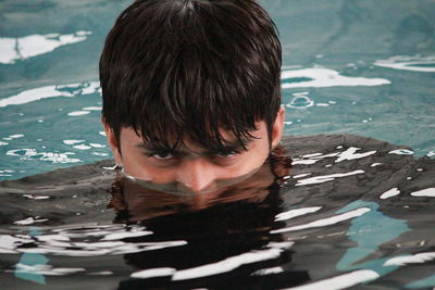 Portrait of man swimming in pool