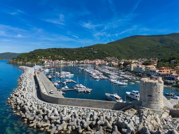 High angle view of townscape by sea against sky
