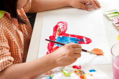 Low angle view of woman hand on table