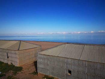 Scenic view of beach against blue sky