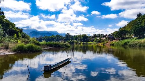 Boat moored in lake against sky