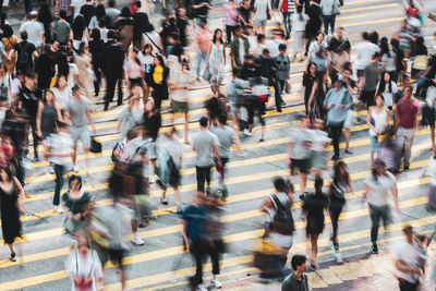 Group of people crossing road in city