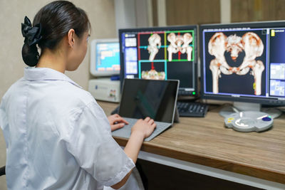 Midsection of woman using mobile phone