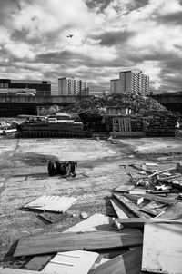 Construction site by buildings against sky in city