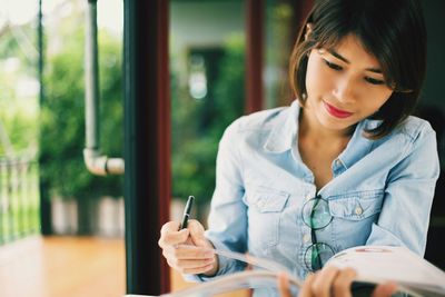 Close-up of young woman sitting on table