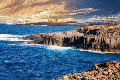 Scenic view of volcanic coast line.