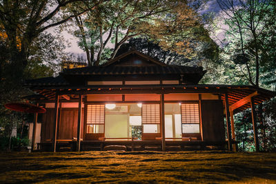 Exterior of house by trees against sky