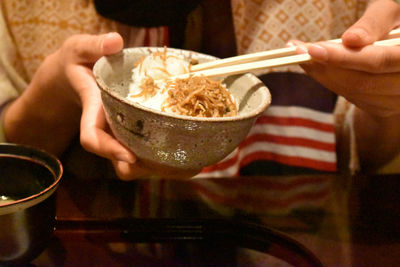 Midsection of man holding ice cream in bowl