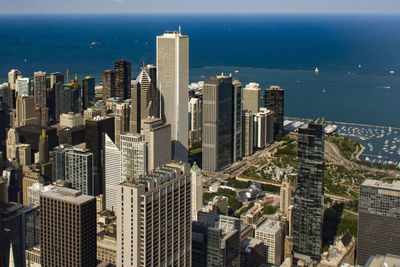 High angle view of buildings by sea against sky