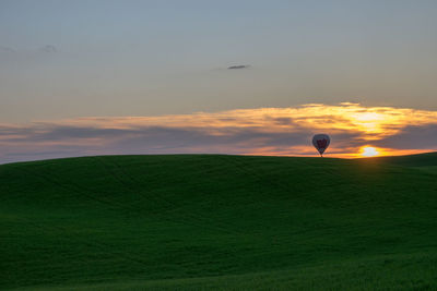 Scenic view of field against sky during sunset