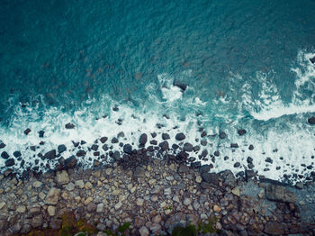 High angle view of pebbles on beach