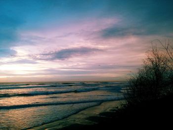 Scenic view of beach against sky during sunset