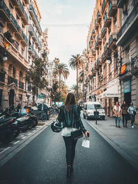Rear view of woman on city street