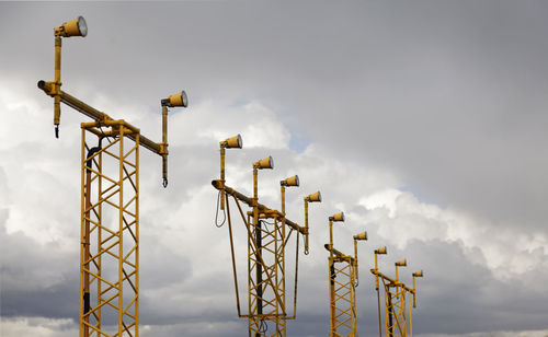 Low angle view of crane against sky