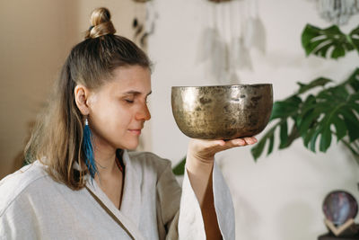 Midsection of woman holding wineglass