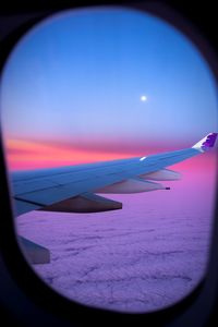 Cropped image of airplane flying over sea