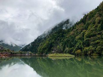 Scenic view of lake and mountains against sky