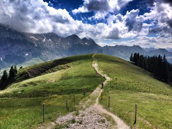 Scenic view of landscape against cloudy sky