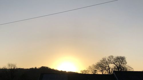 Silhouette trees against sky during sunset