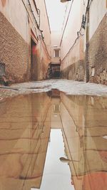 Reflection of buildings in puddle