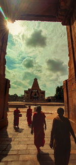 Rear view of people walking in temple