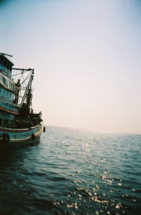 Ship sailing in sea against clear sky