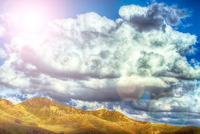 Scenic view of landscape against cloudy sky