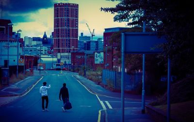 Rear view of people walking on street