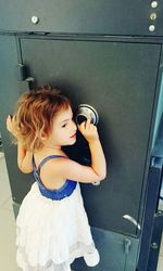 Cute girl in front of safety deposit box