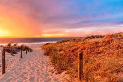 Scenic view of beach against sky during sunset