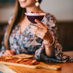 Woman holding ice cream on table