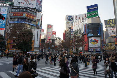 Crowd walking on street in city