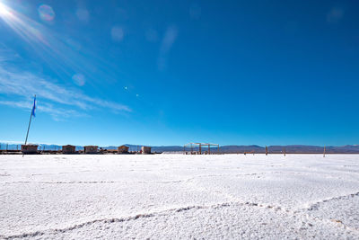 Scenic view of beach against blue sky