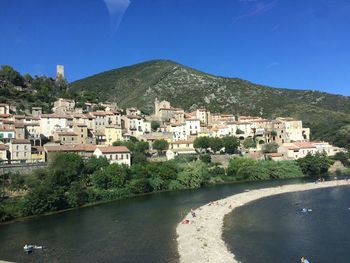Scenic view of residential district against clear blue sky