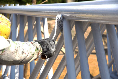 Close-up of man painting on metal