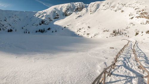 Scenic view of snow covered mountains against sky