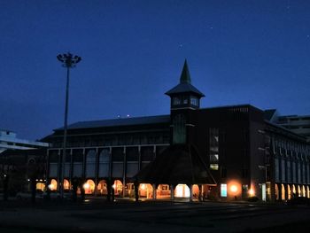 Illuminated building against sky at night