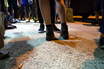 Low section of woman standing on ground
