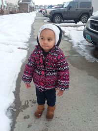 Portrait of cute girl standing in snow