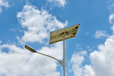 Low angle view of road sign against sky