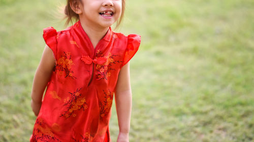 Portrait of a smiling girl standing outdoors