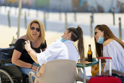 Young woman sitting on table in cafe