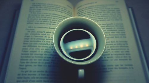 High angle view of coffee on book