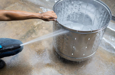 Midsection of man working in water