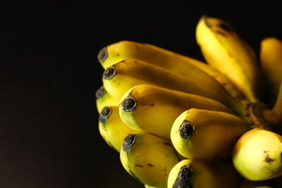 Close-up of yellow fruit against black background