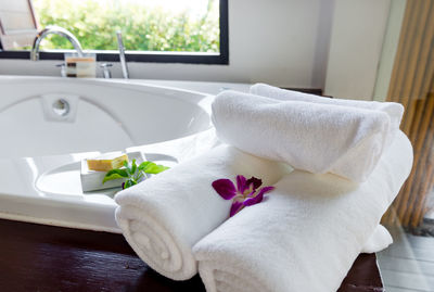 Towels with flower by sink