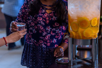 Close-up of woman drinking beer glass