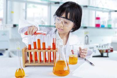 Girl doing scientific experiment in laboratory