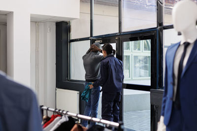 Rear view of man working at airport